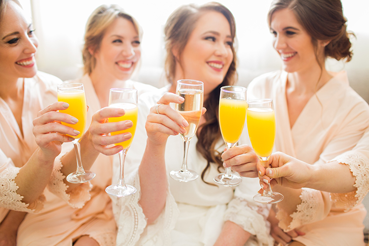 Bridesmaids in Robes Toasting with Mimosas | 15 Wedding Day Morning Of Essentials | photo by Danielle Evans Photography | The Pink Bride® www.thepinkbride.com